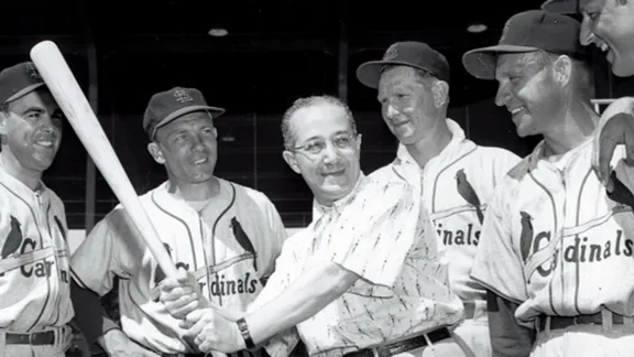 Fred surrounded by members of his team